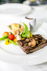 Grilled meat steaks with vegetables, sauce and decoration