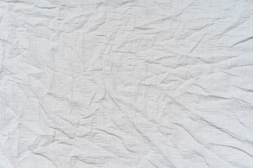 White wrinkled, rippled, surface fabric texture background.