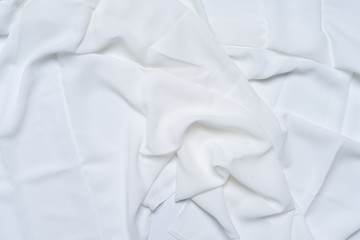 White wrinkled, rippled, surface fabric texture background.
