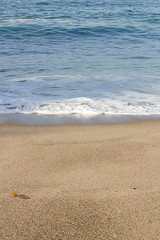 seashore foam crawling up sandy shoreline in california