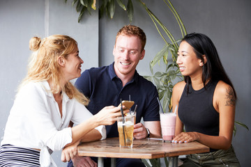 Friends drinking cocktails in cafe