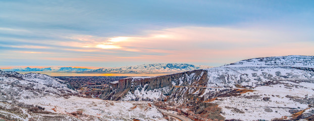 Stunning winter landscape with immense mountain under the cloudy sky