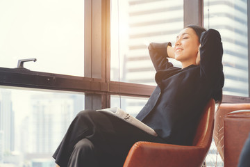 Portrait of relaxed business woman in office. Relax and freedom concept.