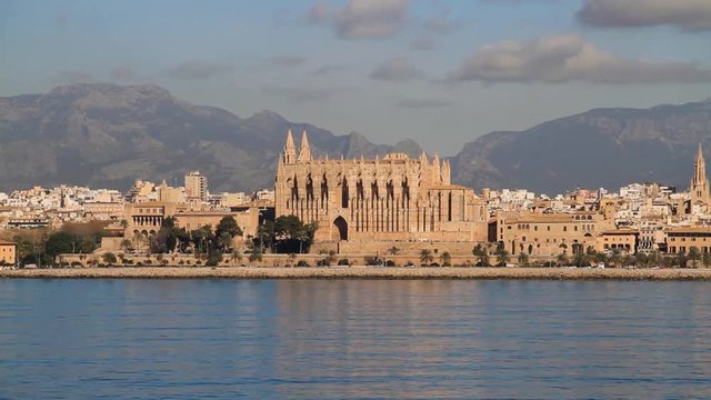 View of the cathedral or Palma de Mallorca. Travelling with the sea and the mountain in background