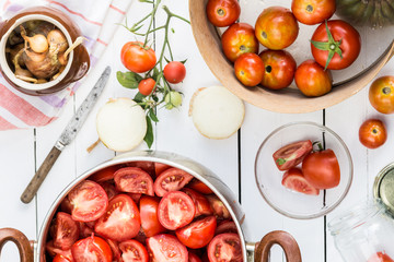 Sliced tomatoes in the pot, tomatoes are prepared for preserves, cooking and food concept, top view