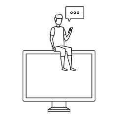 young man using cellphone seated in computer with speech bubble