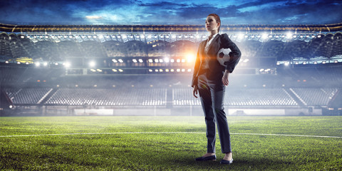 Business lady on football stadium. Mixed media