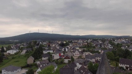 Aerial of a church steeple in a little town on a cloudy day