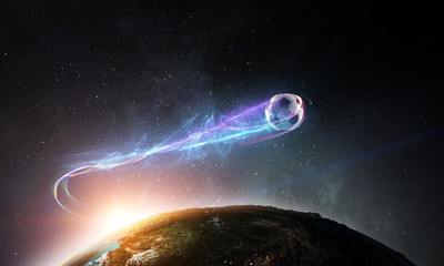 Soccer ball flying in space over planet