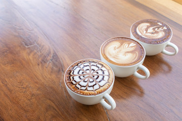 Coffee cup with latte art foam on wood table in coffee shop with copy space.Coffee is one of the most popular beverages.Improve Energy Levels and Burn Fat