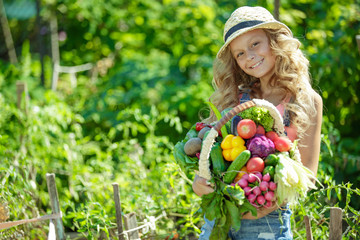 Child with vegetables in nature 