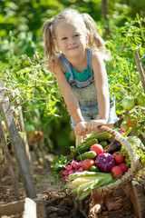 Child with vegetables in nature 