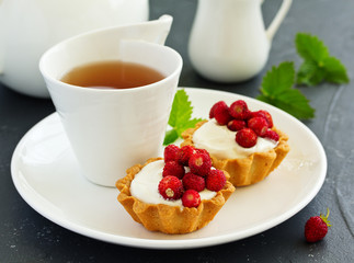 Wild strawberry tartlets with cream filling. delicious summer fruit mini tarts