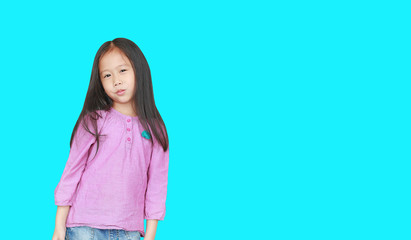 Portrait of happy little Asian child girl isolated on Cyan background with copy space. Kid smiling concept.