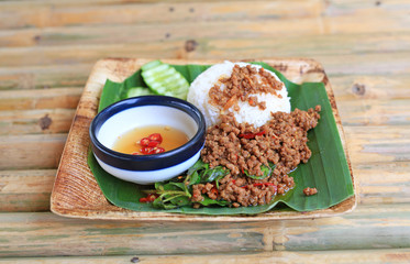Fried pork with sweet basil on rice. Thai popular spicy food.