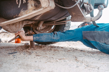 A man raises on a jack 4x4 off road truck