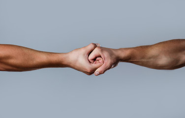Two hands, isolated arm, helping hand of a friend. Friendly handshake, friends greeting. Rescue, helping hand. Male hand united in handshake. Man help hands, guardianship, protection.