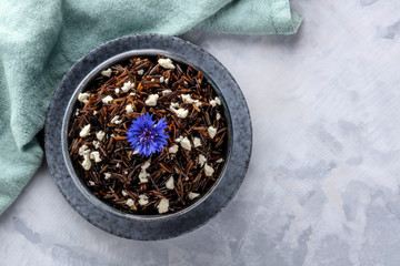 Wild black rice with a lactose-free Feta cheese and an edible flower, a blue cornflower, shot from the top with a place for text