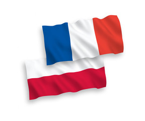 National vector fabric wave flags of France and Poland isolated on white background. 1 to 2 proportion.