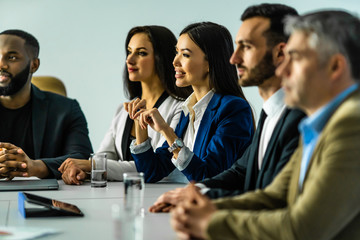 The five business people working at the table