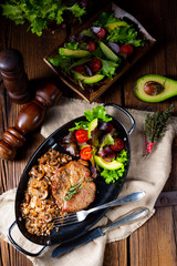 Pork steak with mushrooms and buckwheat groats and mango salad