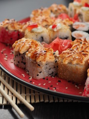 Fresh and delicious sushi set on black table