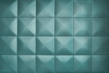 Unusual, beautiful and modern background. Background consists of large pale blue squares. Rhombic light pale blue color wall of big squares.
