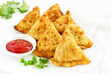 Asian food. Vegetarian samsa (samosas) with tomato sauce