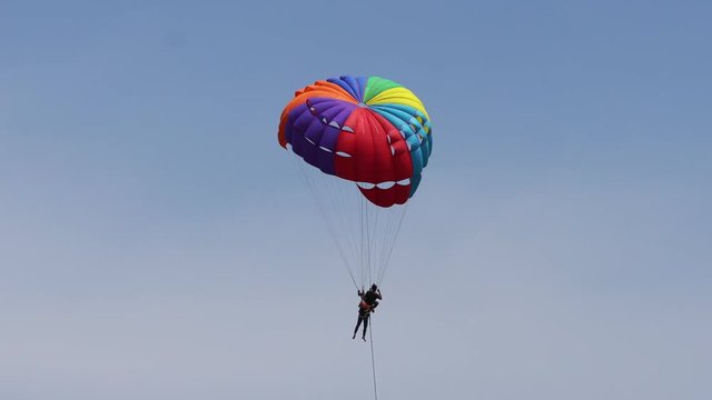 The tourist Flying on a parachute at patong beach