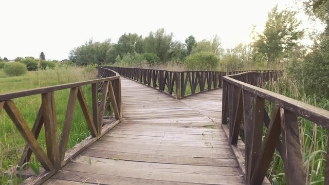 The route with two pathways in nature, made from wooden boards.