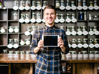 Young man with tablet in cafe