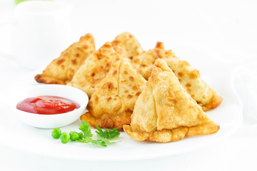 Asian food. Vegetarian samsa (samosas) with tomato sauce