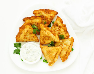 Asian food. Vegetarian samsa (samosas) with tomato sauce