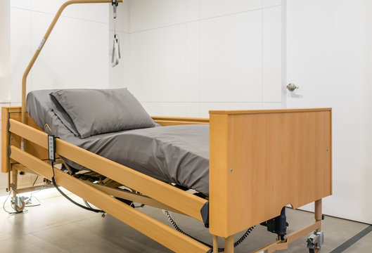 Electrical adjustable patient bed in hospital room. Technology of medical and hospital services.