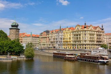 Fototapeta na wymiar Colored houses on the banks of the Vltava River in the old center of Prague, Czech Republic