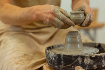 Skilled talented pottery master connecting pieces of clay