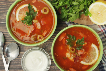 Two bowls with traditional Russian soup solyanka