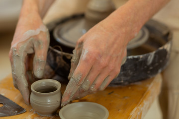 Talented guy with strong hands placing finished tiny pot