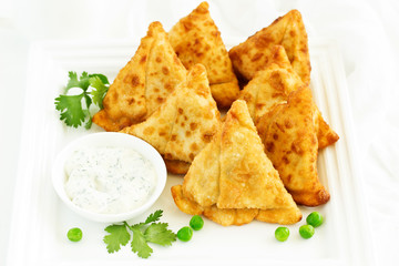 Asian food. Vegetarian samsa (samosas) with tomato sauce