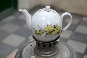 White ceramic kettle on the samovar