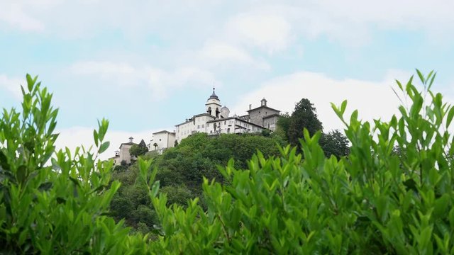 A view from the distance of the Sacred Mountain of Varallo, a christian devotional complex, a unesco world heritage si in Italy. 4k footage