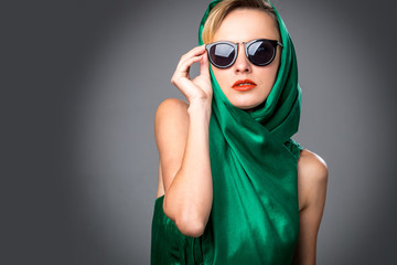 Portrait of a beautiful sexy blonde in green dress, sunglasses and head scarf. Summer, spring fashion woman