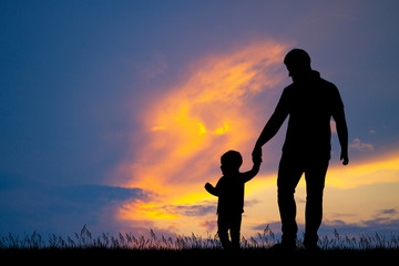 dad with his son at sunset