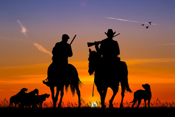 horse hunters at sunset