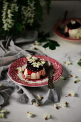 pannacotta with acacia flowers and cherry sauce.