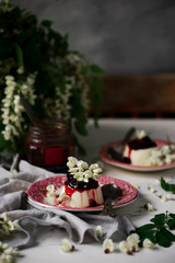 pannacotta with acacia flowers and cherry sauce.