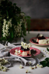 pannacotta with acacia flowers and cherry sauce.