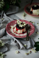 pannacotta with acacia flowers and cherry sauce.