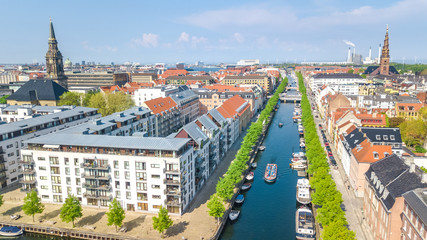 Fototapeta na wymiar Beautiful aerial view of Copenhagen skyline from above, Nyhavn historical pier port and canal with color buildings and boats in the old town of Copenhagen, Denmark