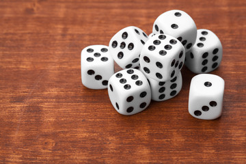 Dice on wooden table. Background for casino games.
